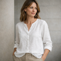 Woman wearing a white shirt against a neutral background